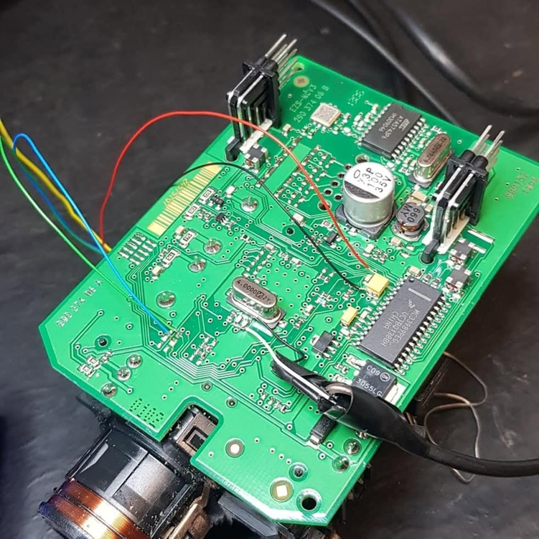 Close-up of an automotive circuit board under repair